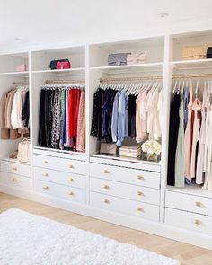 a white closet filled with lots of clothes