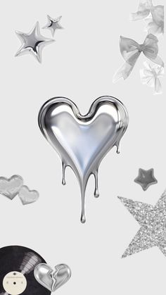 silver hearts, stars and vinyl records are featured in this artistic photo with white background