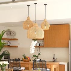 a kitchen with wooden cabinets and hanging lights