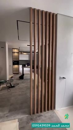 an empty living room with wooden slats on the wall