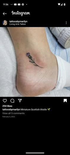 a small flower tattoo on the foot