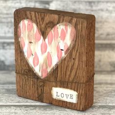 a wooden block with a heart painted on it