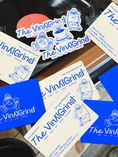 some blue and white stickers sitting on top of a record player's turntable