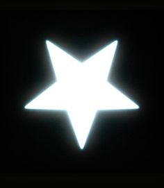 a white star on a black background in the dark