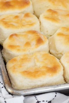 a pan filled with biscuits on top of a table