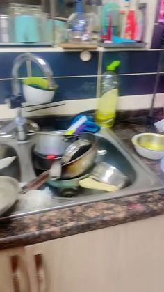 a kitchen sink filled with dirty dishes and utensils on top of the counter