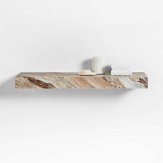 a marble shelf with a cup and towel on it