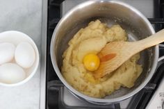 an egg is being cooked in a pot on the stove