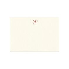 a white card with a red bow on it