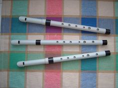 three white flutes sitting on top of a checkered table cloth