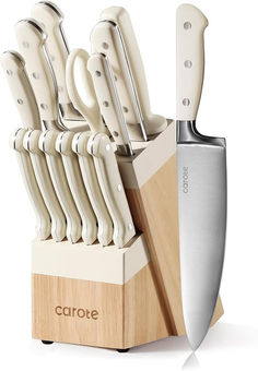 a set of knives sitting on top of a wooden block