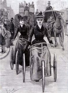 two women riding on the back of bicycles in an old time fashion, with horses and carriages behind them