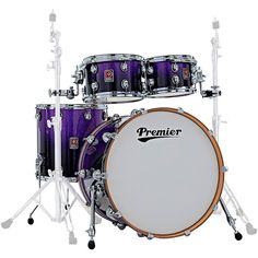 a purple and white drum set sitting on top of each other