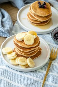 pancakes with banana slices and blueberries on plates