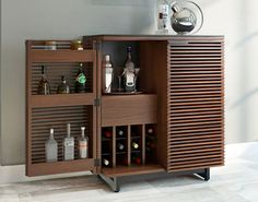 a wooden cabinet with bottles and glasses on it