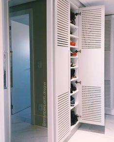 a white closet with several pairs of shoes in it