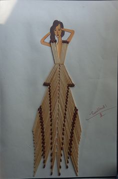 a drawing of a woman in a dress made out of matchesticks on a sheet of paper