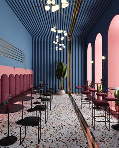 the interior of a restaurant with pink and blue walls, black chairs, and potted plants