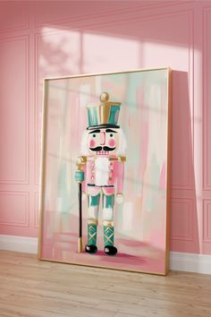 a painting of a nutcracker is on display in a room with pink walls