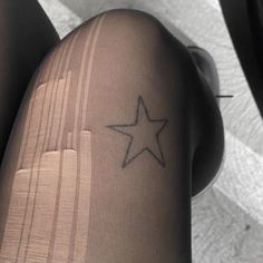 a person's leg with a star tattoo on the lower half of their leg