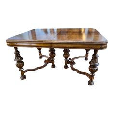 an antique wooden table with carved legs