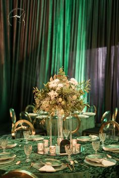 a table set with place settings and centerpieces