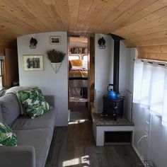 a living room filled with furniture and a fire place next to a wall mounted heater