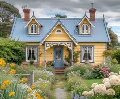 a yellow house with blue roof surrounded by flowers