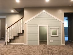 an empty house with stairs leading up to the second floor and another room in the background