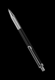 a black and silver pen on a black background