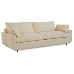 a cream colored couch with two pillows on the armrests and one pillowed back