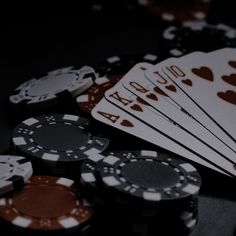 poker chips and cards on a table with one falling from the top to the bottom