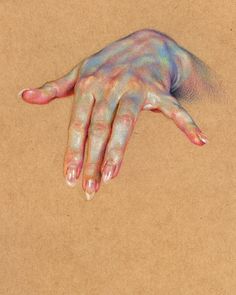 a person's hand painted with multicolors on a brown paper background,