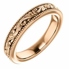 an intricately designed wedding band in yellow gold