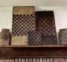 several vases and boxes sitting on top of a shelf