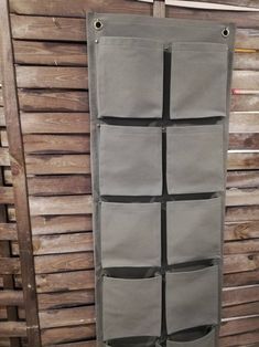 an over the door storage bag hanging on a wooden wall