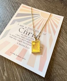 a small gold necklace with the words i am a blessing of christ printed on it