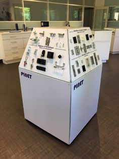 an office cubicle with several electronic devices on it