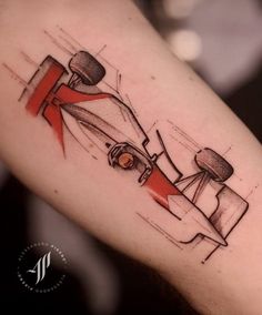 a tattoo on the arm of a man with a racing car