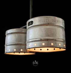 an industrial style light fixture with two lights on each side and the words miller brewing above it