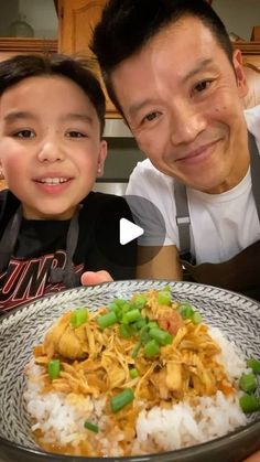 a man and boy are posing with a plate of food in front of the camera