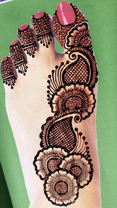 the foot is decorated with henna and flowers