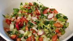 a white bowl filled with lots of veggies