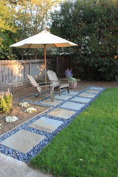 a patio with chairs and an umbrella in the middle of it, surrounded by grass