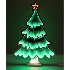 a lit up christmas tree sitting on top of a table