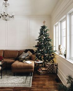 a living room with a christmas tree in the corner