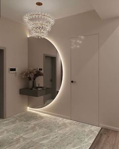 a bathroom with a chandelier, mirror and lights on the wall next to it