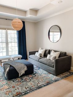 a living room filled with furniture and a large rug