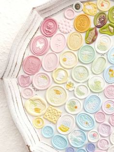 a tray filled with lots of different types of buttons on top of a white surface