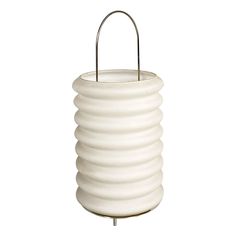 a white candle holder on a metal stand